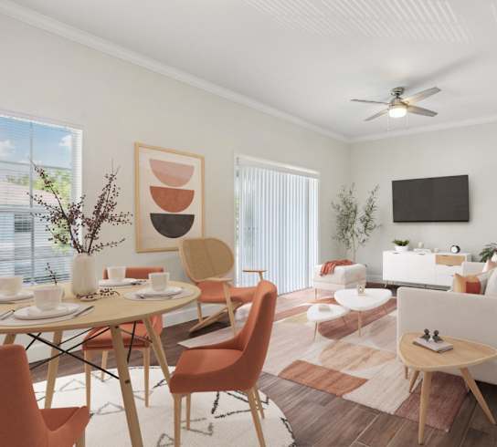 A living room with a dining table and chairs.